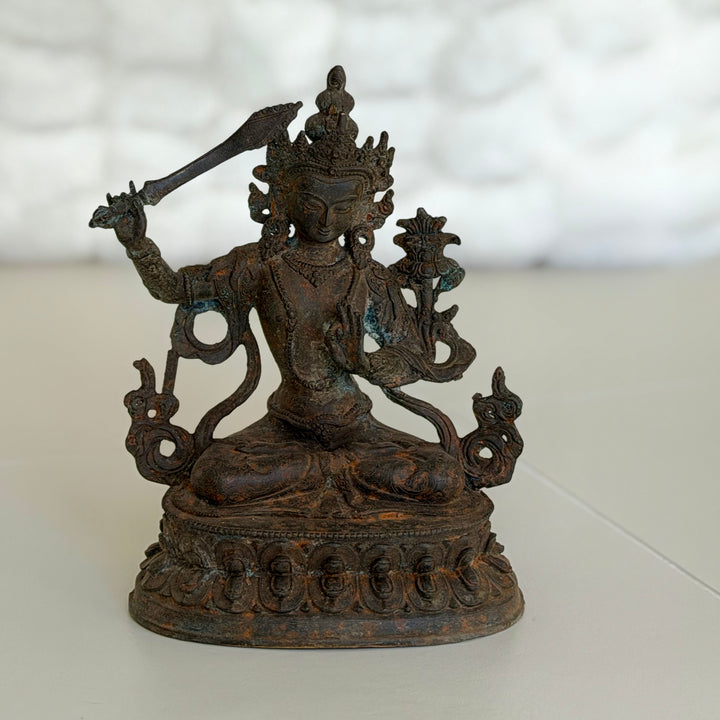 Bodhisattva Manjushri seated on lotus base, front view.