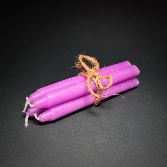 Candle set of four in purple color, tied together with a thin rope.