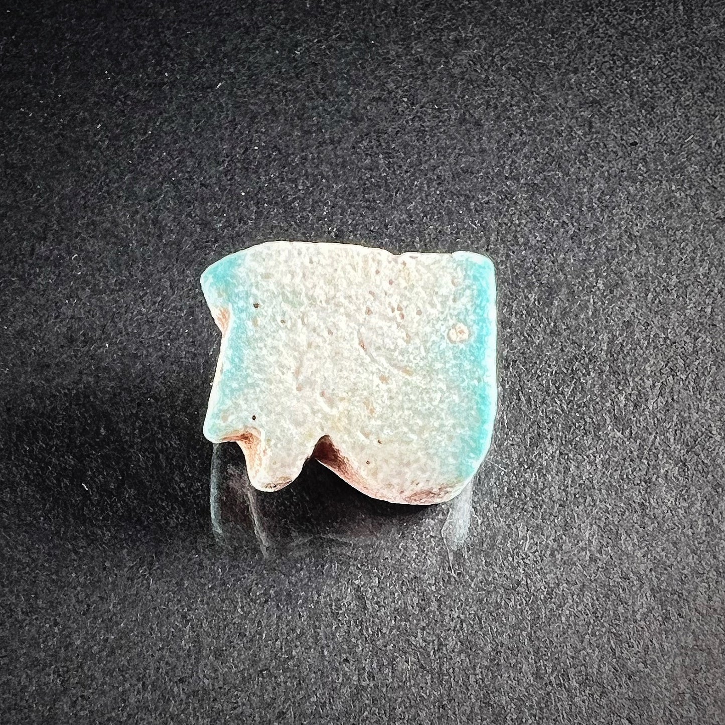  Wedjat-amulet from ancient Egypt made out of faience. Back side photo.