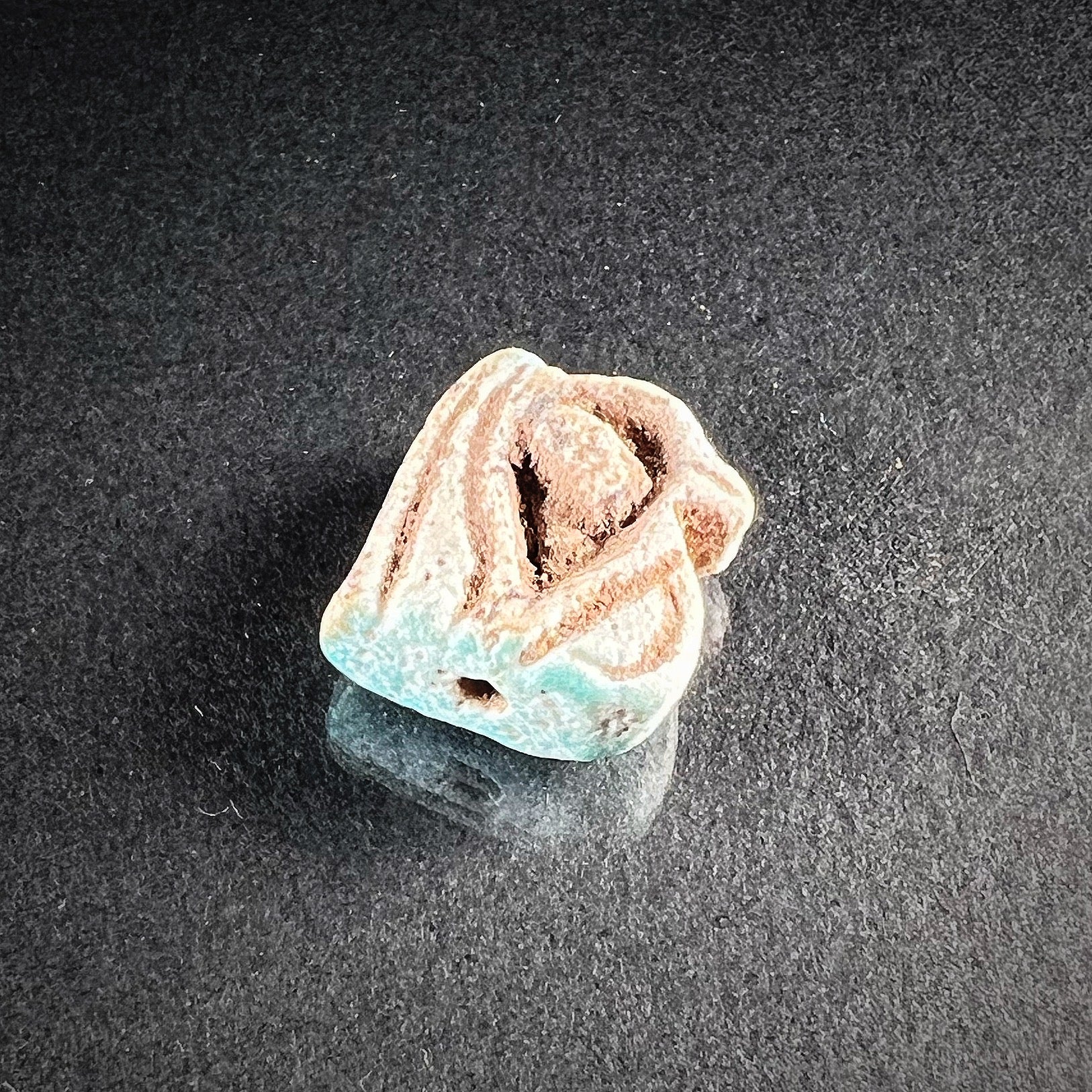  Wedjat-amulet from ancient Egypt made out of faience. Top view photo.