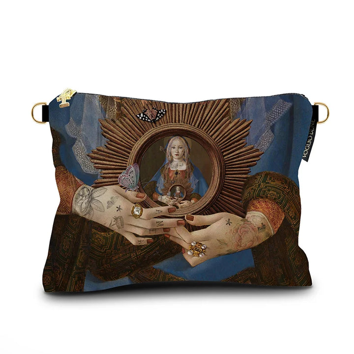 Kuvassa Voglio Bene -samettilaukun takapuoli Madonna Suprema -kuvituksella. Lähikuva naisen käsistä, jotka pitävät aurinkoa, jonka keskellä huntuun pukeutunut nainen toistuu.
The back of the Voglio Bene velvet bag with Madonna Suprema illustration. Close-up of the woman’s hands holding a sun, with the veiled woman depicted at its center.