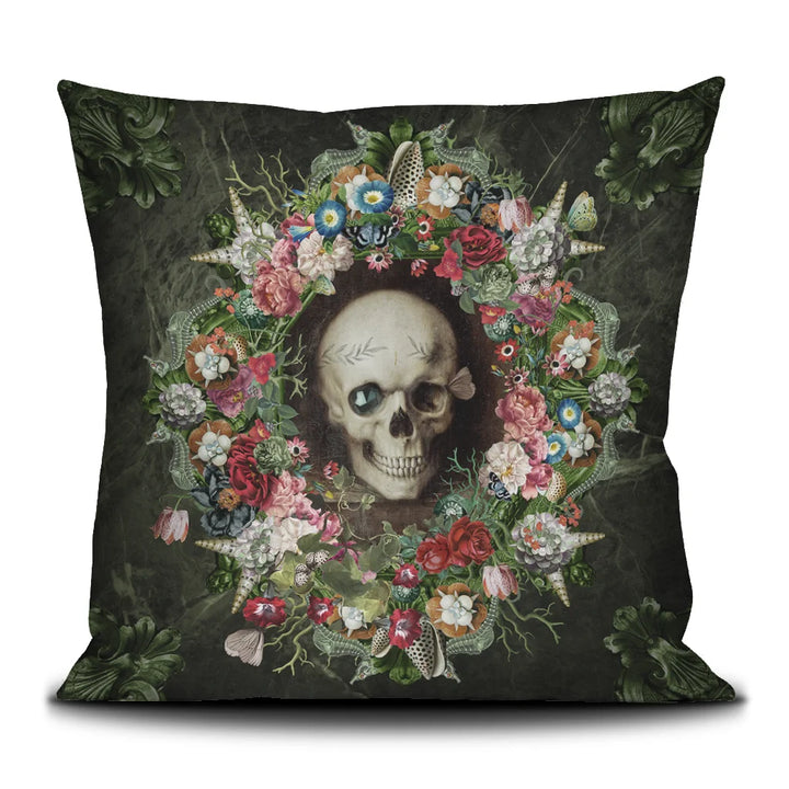 Voglio Bene The Froth of the Days -tyynyn etunäkymä, jossa pääkalloa koristavat kukat ja simpukat yksityiskohtaisessa kuvituksessa.
Front view of a Voglio Bene The Froth of the Days cushion, showing a skull adorned with flowers and seashells in detailed artwork.