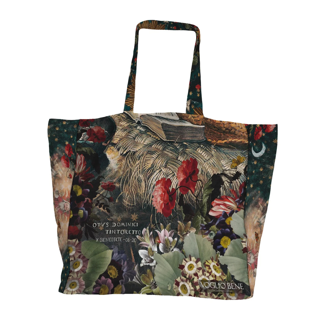 Voglio Bene Marie Magdeline -tote bag takanäkymä. Kuvassa kukka- ja heinäasetelma koristeellisella taustalla.
Back view of a Voglio Bene Marie Magdeline tote bag. The image features a floral and grass arrangement on a decorative background.