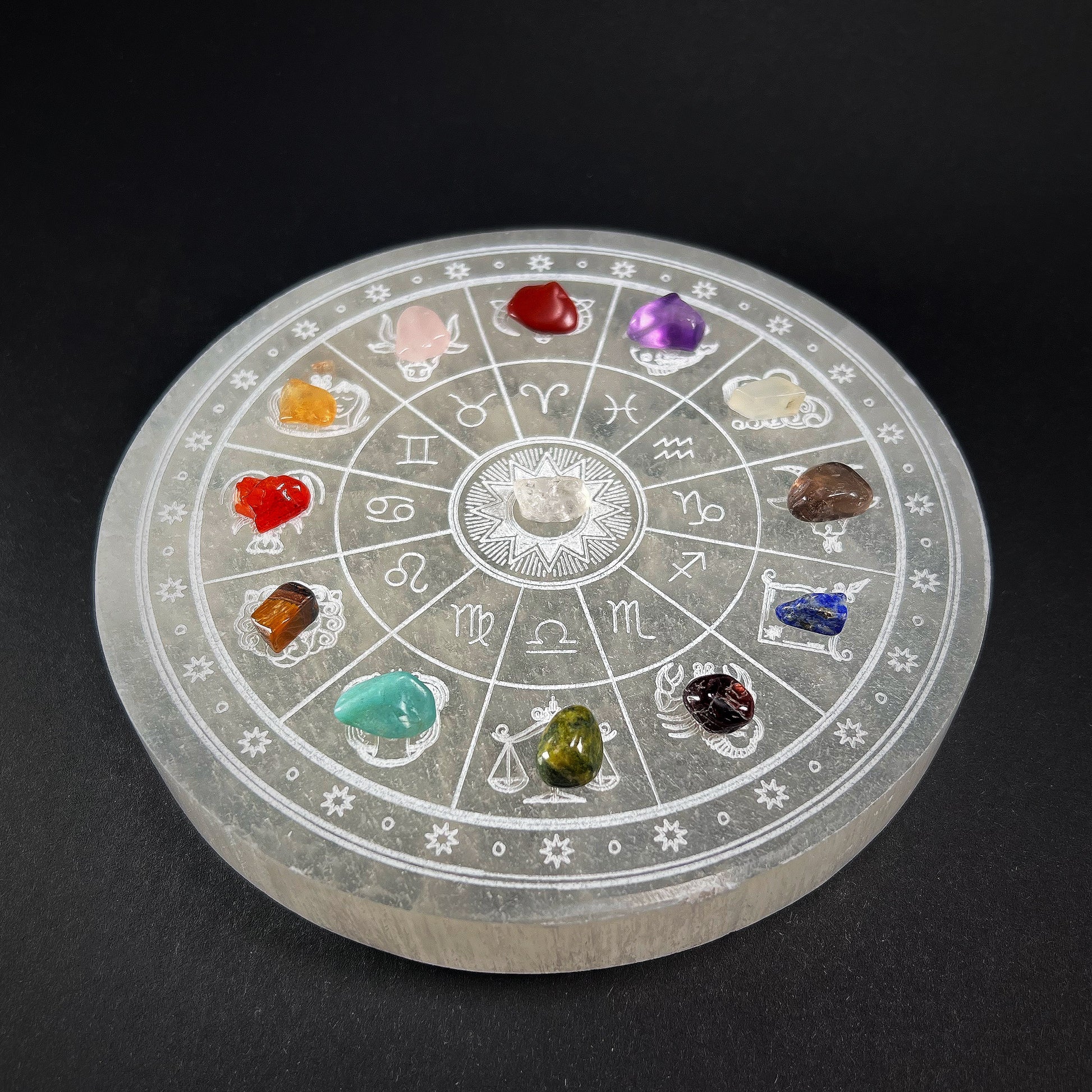 Round selenite plate with carved zodiac signs, added with different beautiful gem stones for each zodiac. Full frontal view.
