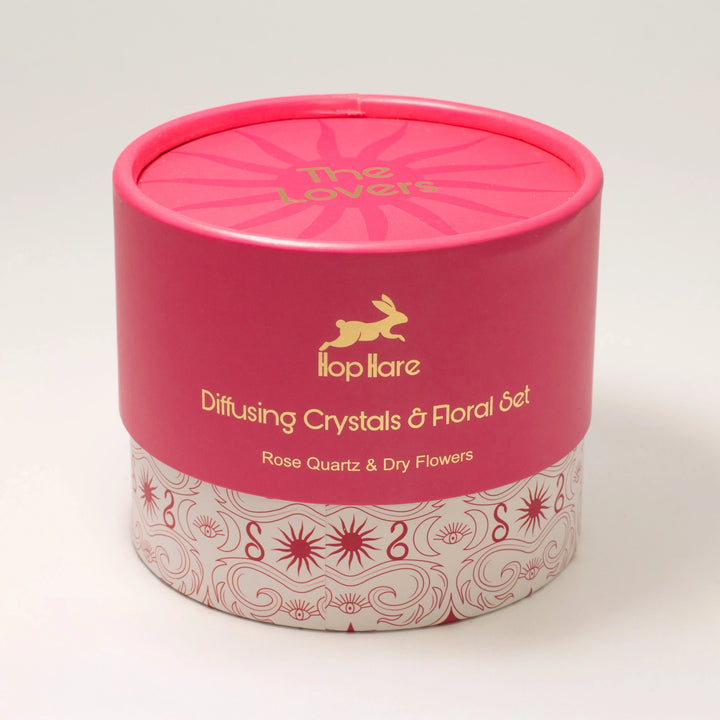 The pink cylindrical packaging of the Hop Hare The Lovers crystal diffuser.