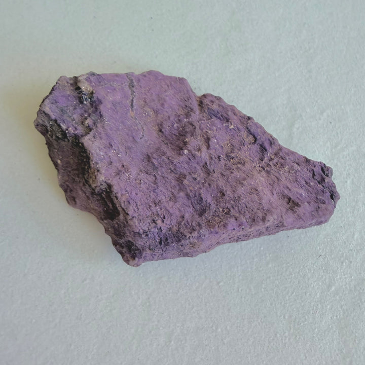Close-up of Purpurite Stone 1 showing an uneven violet mineral surface.