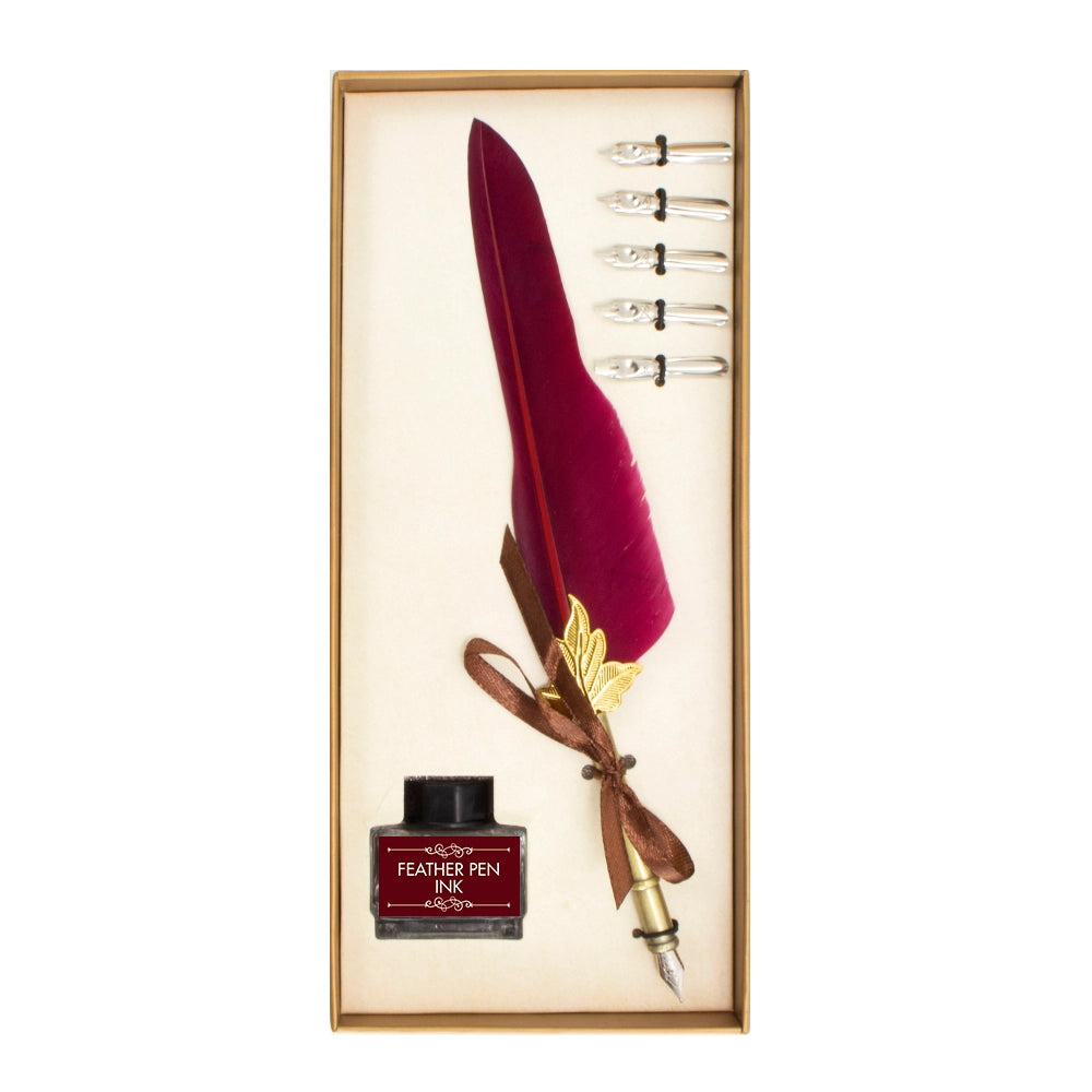 Burgundy feather quill pen, five spare nibs and a bottle of ink in an open gold-coloured gift box.