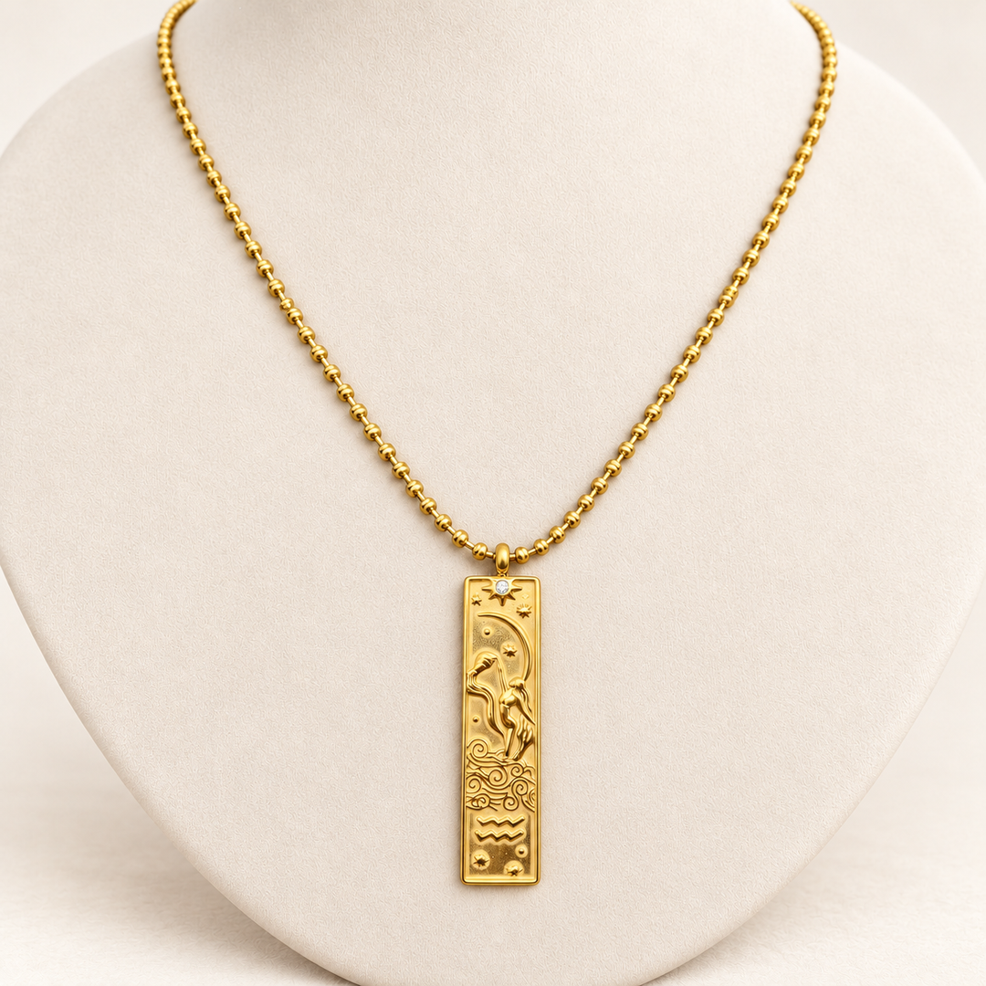 18K gold-plated Zodiac necklace, Aquarius, on a light-coloured jewellery bust.