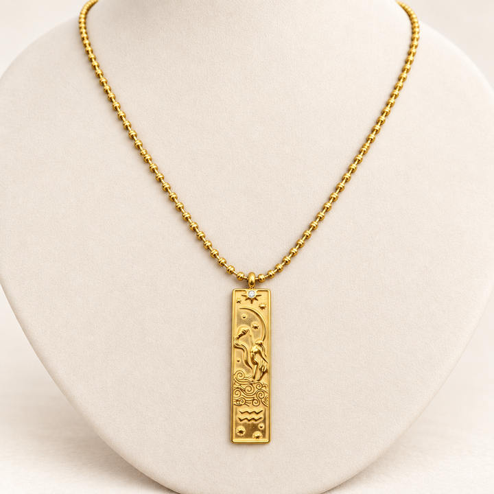 18K gold-plated Zodiac necklace, Aquarius, on a light-coloured jewellery bust.