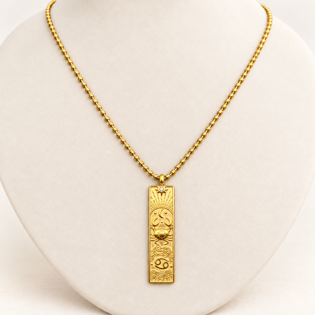 18K gold-plated Zodiac necklace, Cancer, on a light-coloured jewellery bust.