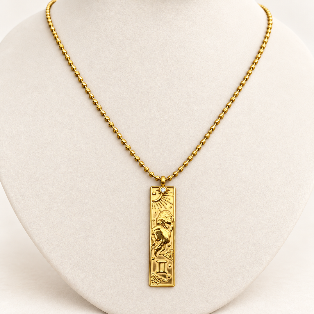 18K gold-plated Zodiac necklace, Gemini, on a light-coloured jewellery bust.