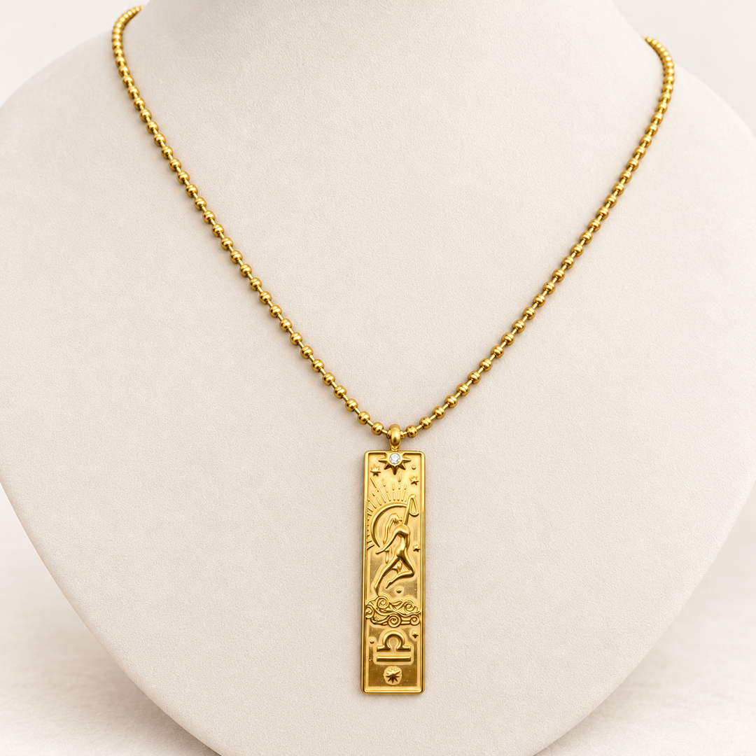 18K gold-plated Zodiac necklace, Libra, on a light-coloured jewellery bust.
