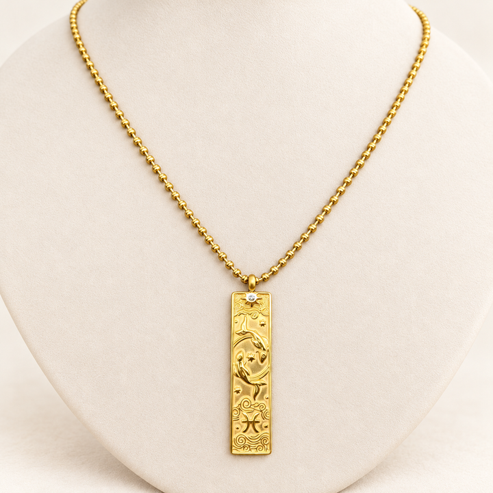 18K gold-plated Zodiac necklace, Pisces, on a light-coloured jewellery bust.