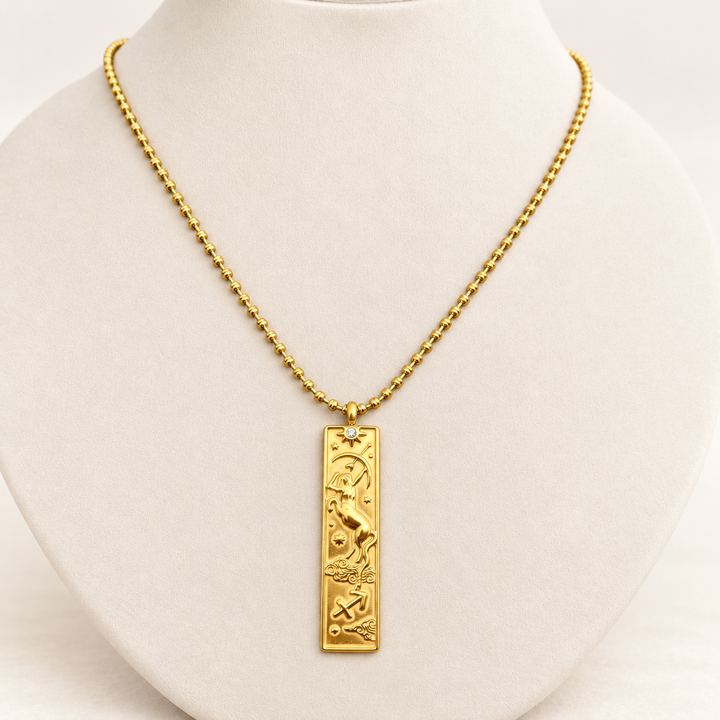 18K gold-plated Zodiac necklace, Sagittarius, on a light-coloured jewellery bust.
