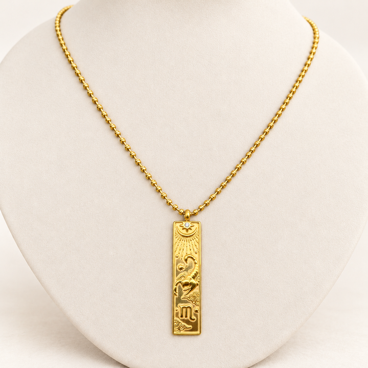 18K gold-plated Zodiac necklace, Scorpio, on a light-coloured jewellery bust.